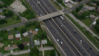 4.8K stock footage aerial video tilting from a bird's eye of light traffic on Interstate 95 in Baltimore, Maryland, to reveal suburban neighborhoods Aerial Stock Footage | AX78_125