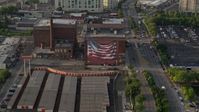 4.8K stock footage aerial video of an American flag mural on a warehouse building in Philadelphia, Pennsylvania, Sunset Aerial Stock Footage | AX80_030