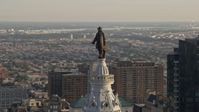 4.8K stock footage aerial video approaching the William Penn statue atop Philadelphia City Hall, Pennsylvania, Sunset Aerial Stock Footage | AX80_034