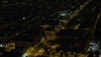 4.8K stock footage aerial video of city streets and dark warehouse building in South Philadelphia, Pennsylvania, Night Aerial Stock Footage | AX81_044