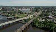 4.8K stock footage aerial video approach and orbit bridges spanning the Delaware River, reveal commuter train and courthouse, Trenton, New Jersey Aerial Stock Footage | AX82_067E