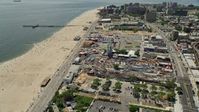 4.8K stock footage aerial video orbiting Luna Park and the boardwalk beside Coney Island Beach, Brooklyn, New York City Aerial Stock Footage | AX83_215E