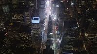 4K stock footage aerial video Tilting up to reveal Times Square, Midtown Manhattan, New York, New York, night Aerial Stock Footage | AX85_043