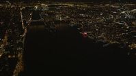 4K stock footage aerial video Tilt up from East River, revealing Queensboro Bridge, New York, New York, night Aerial Stock Footage | AX85_060