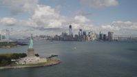 4K stock footage aerial video Statue of Liberty, Liberty Island, Lower Manhattan skyline, New York, New York Aerial Stock Footage | AX87_002