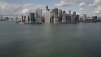 4K stock footage aerial video Tilt up from bay to reveal Lower Manhattan skyscrapers, New York, New York Aerial Stock Footage | AX87_046