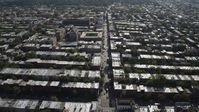 4K stock footage aerial video of following a street past row houses near 8th Avenue Armory, Brooklyn, New York Aerial Stock Footage | AX88_019