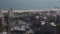 4K stock footage aerial video flyby apartment buildings toward the beach, Luna Park in Coney Island, Brooklyn, New York Aerial Stock Footage | AX88_042