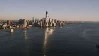 4K stock footage aerial video of Lower Manhattan skyscrapers, from Hudson River, New York, New York, sunset Aerial Stock Footage | AX93_003
