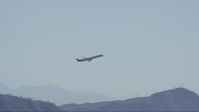 HD stock footage aerial video of commercial jet ascending toward blue skies over Burbank, California Aerial Stock Footage | CAP_012_002