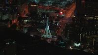 HD stock footage aerial video of flying away from a Ferris wheel at nighttime, reveal skyscraper, Downtown Atlanta, Georgia Aerial Stock Footage | CAP_013_063