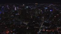 HD stock footage aerial video of passing tall skyscrapers at night, zoom closer to US Bank Tower, Downtown Los Angeles, California Aerial Stock Footage | CAP_018_210