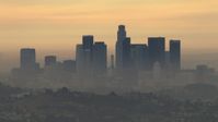 HD stock footage aerial video of the smoggy skyline, cloudy, Downtown Los Angeles, California, sunset Aerial Stock Footage | CBAX01_086