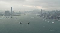 4K stock footage aerial video of ships sailing Victoria Harbor between Kowloon and Hong Kong Island, China Aerial Stock Footage | DCA02_014