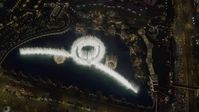 4K stock footage aerial video of flying away from Bellagio Fountain water show, revealing The Bellagio, Las Vegas, Nevada Night Aerial Stock Footage | DCA03_025