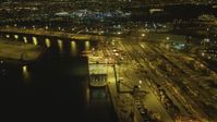 4K stock footage aerial video of flying by cargo ship, cranes, containers, Port of Long Beach, California, night Aerial Stock Footage | DCA07_132