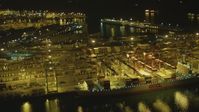4K stock footage aerial video of flying by cargo ship, cranes, containers, Port of Long Beach, California, night Aerial Stock Footage | DCA07_135