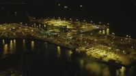 4K stock footage aerial video of approaching cargo containers, cranes at the Port of Long Beach, California, night Aerial Stock Footage | DCA07_139