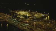 4K stock footage aerial video of approaching cargo containers, cranes, Port of Long Beach, California, night Aerial Stock Footage | DCA07_140