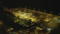 4K stock footage aerial video of approaching cargo ship and cranes, Port of Long Beach, California, night Aerial Stock Footage | DCA07_141