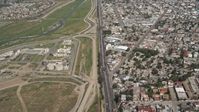 4K stock footage aerial video of following a border highway and fence on the US/Mexico Border, Tijuana Aerial Stock Footage | DCA08_046