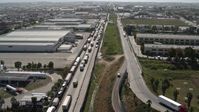 4K stock footage aerial video of a line of trucks by warehouses, US/Mexico Border, Tijuana Aerial Stock Footage | DCA08_083E