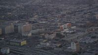5K stock footage aerial video track a police helicopter flying over Downtown Los Angeles at twilight, California Aerial Stock Footage | DCLA_051