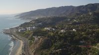 5K stock footage aerial video bird's eye view of Highway 1 and tilt to reveal hilltop homes in Pacific Palisades, California Aerial Stock Footage | DCLA_134