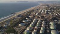 5K stock footage aerial video fly over oil tanks at refinery to approach beach in El Segundo, California Aerial Stock Footage | DCLA_195