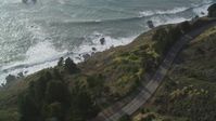5K stock footage aerial video Bird's eye view of Highway 1 winding along hills above the coast, Big Sur, California Aerial Stock Footage | DCSF03_033