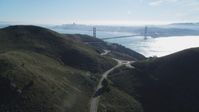 5K stock footage aerial video Flyby the Marin Headlands, eclipsing Golden Gate Bridge, San Francisco skyline in background, Marin County, California Aerial Stock Footage | DCSF05_047