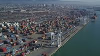 5K stock footage aerial video Flying by cargo cranes, and stacks of shipping containers, Port of Oakland, Oakland, California Aerial Stock Footage | DCSF05_077