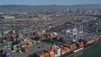 5K stock footage aerial video Flying by cargo cranes, shipping containers, cargo ships, Port of Oakland, Oakland, California Aerial Stock Footage | DCSF05_078