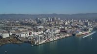 5K stock footage aerial video Flying by Port of Oakland Inner Harbor, Downtown Oakland in the background, California Aerial Stock Footage | DCSF05_080