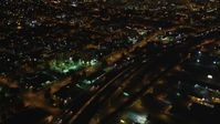 5K stock footage aerial video Tilt from light traffic on Interstate 880, revealing Downtown Oakland, California, night Aerial Stock Footage | DCSF06_091