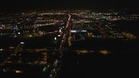 5K stock footage aerial video Follow I-880 toward O.co Coliseum and Oracle Arena, tilt down, Oakland, California, night Aerial Stock Footage | DCSF06_100