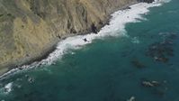 5K Aerial Video Bird's eye view of kelp near waves rolling toward coastal cliffs, Big Sur, California Aerial Stock Footage | DCSF11_033