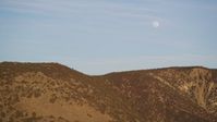 5K Aerial Video Flying by the a ridge in the Temblor Range with the moon overhead, San Luis Obispo County, California Aerial Stock Footage | DCSF12_013