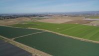 5K stock footage aerial video of flying over crop fields, with wide view of rural landscape in Santa Maria, California Aerial Stock Footage | DFKSF02_001