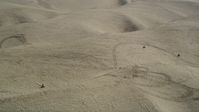 5K stock footage aerial video of orbiting ATV riders cruising over the sand dunes, Pismo Dunes, California Aerial Stock Footage | DFKSF02_021