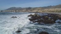 5K stock footage aerial video of flying over waves rolling into rock formations, coastal cliffs, Avila Beach, California Aerial Stock Footage | DFKSF02_060