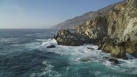 5K stock footage aerial video of flying low beside coastal cliffs and over crashing waves, Big Sur, California Aerial Stock Footage | DFKSF03_123