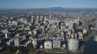 5K stock footage aerial video approach and pan across city buildings in Downtown Oakland, California Aerial Stock Footage | DFKSF05_002