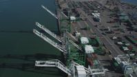 5K stock footage aerial video of flying over four cargo cranes at the Port of Oakland, California Aerial Stock Footage | DFKSF05_093