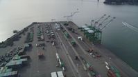5K stock footage aerial video of an orbit of the cargo cranes and shipping containers at the Port of Oakland, California Aerial Stock Footage | DFKSF06_019