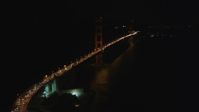 5K stock footage aerial video of flying over heavy traffic to approach the Golden Gate Bridge, San Francisco, California, night Aerial Stock Footage | DFKSF07_035
