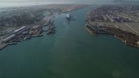 5K stock footage aerial video of tilting from Oakland Inner Harbor revealing cargo ship in Port of Oakland, California Aerial Stock Footage | DFKSF09_017