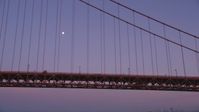 5K stock footage aerial video of flying by the Golden Gate Bridge with a view of the moon, San Francisco, California, twilight Aerial Stock Footage | DFKSF14_035