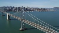 5K stock footage aerial video of flying over the Bay Bridge and panning to Downtown San Francisco skyline, California Aerial Stock Footage | DFKSF15_007
