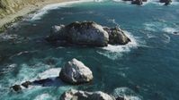 5K stock footage aerial video of flying over large coastal rock formations in the ocean, Big Sur, California Aerial Stock Footage | DFKSF16_121